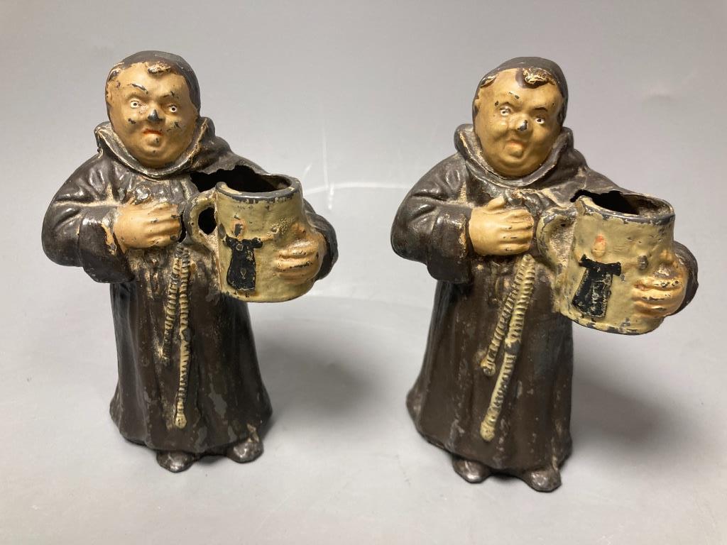 A pair of painted spelter monk spill vases,17cm, and a postcard album